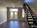 Bright living room with dark hardwood floors and staircase at 2125 Southend Dr # 320, Charlotte, NC 28203