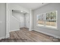 Bright foyer featuring hardwood floors, large window, and an open staircase at 215 Lake George Dr, Shelby, NC 28152