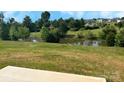 Scenic view of a lush pond surrounded by trees in a quiet neighborhood at 215 Lake George Dr, Shelby, NC 28152