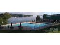 Community pool and clubhouse area with lounge chairs and dining tables overlooking a misty lakefront at 237 Roxboro Dr, Mount Gilead, NC 27306
