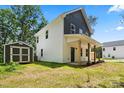 Spacious backyard with a storage shed complements this charming two-story home with two-tone facade at 25 Mickley Ave, Bessemer City, NC 28016