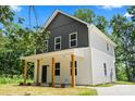 Charming two-story home boasts a welcoming front porch with wood columns and a modern two-tone facade at 25 Mickley Ave, Bessemer City, NC 28016