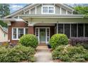 Charming brick home showcasing a beautifully landscaped front yard with an inviting front door at 255 South Academy St, Mooresville, NC 28115