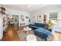 Bright living room featuring hardwood floors, a fireplace, and a comfortable blue sectional sofa at 255 South Academy St, Mooresville, NC 28115