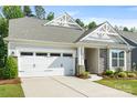 Charming home featuring a gray roof, stone accents, manicured lawn and an attached two car garage at 2658 Manor Stone Way, Indian Trail, NC 28079