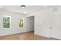 Bright living room with light hardwood floors, white walls, recessed lighting, and large windows offering scenic views at 27 Mickley Ave, Bessemer City, NC 28016