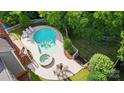 Aerial view of backyard oasis featuring a large pool, hot tub, lounge chairs and outdoor dining area at 2725 Cotton Planter Ln, Charlotte, NC 28270