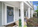 Inviting front porch with a blue door, decorative wreath, and a charming welcome mat, creating a warm entrance at 295 Helton Ln, Fort Mill, SC 29708