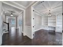 Open view of office space featuring dark hardwood floors, custom built-in shelving, and recessed lighting at 295 Helton Ln, Fort Mill, SC 29708