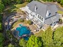 Aerial view showcasing a large in-ground pool, multiple patios, and lush landscaping at 2971 Kaneland Ct, Rock Hill, SC 29732