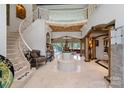 Grand foyer featuring a spiral staircase, marble floors, and sophisticated decor at 2971 Kaneland Ct, Rock Hill, SC 29732