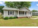 Beautiful one-story home boasting a cozy front porch and manicured lawn at 3103 Suggs St, Belmont, NC 28012