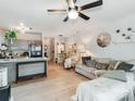 Bright living room featuring hardwood floors, stylish decor, a ceiling fan, and a comfortable sofa at 3308 Selwyn Farms Ln # 2, Charlotte, NC 28209