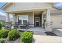 Charming front porch with rocking chairs, stone accents, and a decorative wreath on the front door at 3833 Isenhour Rd, Kannapolis, NC 28081