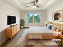 Brightly lit bedroom with neutral tones, a ceiling fan, and views of the neighborhood at 4105 Galloway Park Dr, Charlotte, NC 28262