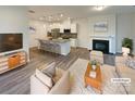 Bright living room showcasing modern furniture, fireplace, and adjacent open kitchen at 4105 Galloway Park Dr, Charlotte, NC 28262