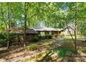 Charming wood and stone home with mature landscaping creating a private, wooded setting at 4417 Walter Nelson Rd, Mint Hill, NC 28227