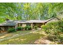 Lovely front exterior of a one story house, surrounded by beautiful, mature trees at 4417 Walter Nelson Rd, Mint Hill, NC 28227