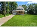 Two-story home with a covered porch, a garage, and lush front yard at 4541 Kings Ct, Hickory, NC 28602