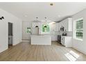 Stylish white kitchen with modern pendant lighting and stainless steel appliances at 4541 Kings Ct, Hickory, NC 28602