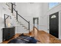 Grand foyer with a staircase, hardwood floors, and elegant trim work throughout at 4622 Cotton Creek Dr, Charlotte, NC 28226