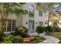 Lovely white brick home featuring an elegant gray front door and well-manicured landscaping at 4622 Cotton Creek Dr, Charlotte, NC 28226