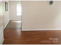 Bright living room featuring wood flooring and a view into adjacent room with neutral walls at 517 N Pine Ln, Wadesboro, NC 28170