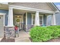 Inviting front porch with stone accents, comfortable seating, and a welcoming entrance at 528 Sandbar Pt, Clover, SC 29710