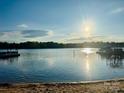 Beautiful waterfront view with dock and glistening water in the sunny afternoon at 554 Isle Of Pines Rd, Mooresville, NC 28117
