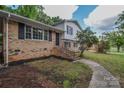 Charming two-story home featuring brick and siding with a well-manicured lawn and inviting front entrance at 6921 Idlewild Rd, Charlotte, NC 28212