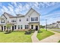 Charming white two-story townhome featuring a welcoming front porch and beautifully landscaped front yard at 720 Herlong S Ave, Rock Hill, SC 29732