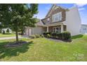 Beautifully landscaped front yard featuring a lush green lawn and trimmed shrubs, perfect curb appeal at 10211 Snowbell Ct, Charlotte, NC 28215