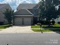 Attractive two-story home with a two-car garage, stone accents, and landscaped front yard, set on a sunny street at 10211 Snowbell Ct, Charlotte, NC 28215