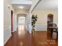 Inviting foyer with hardwood floors, arched doorways, and decorative wainscoting providing an elegant entrance at 10211 Snowbell Ct, Charlotte, NC 28215