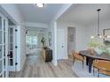 Open foyer with wood-look floors, modern light fixture, and decorative accents at 1025 Harrogate Dr, Bessemer City, NC 28016
