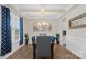 Dining room featuring coffered ceiling, wainscoting, and ample natural light at 107 Hornbeam Ln, Mooresville, NC 28117