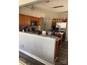Open kitchen featuring stainless appliances, granite countertops, wooden cabinets and stylish pendant lighting at 10826 Claude Freeman Dr, Charlotte, NC 28262