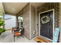 Inviting front porch with seating, decorative wreath on front door and welcome mat, showing curb appeal at 11518 Solstice Way, Huntersville, NC 28078