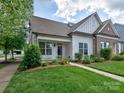 Charming home featuring manicured lawn, sidewalk, and inviting front entrance at 13421 Copley Square Dr, Huntersville, NC 28078