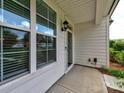 Inviting front porch features classic design elements, ample natural light, and pleasant views at 13421 Copley Square Dr, Huntersville, NC 28078