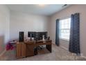 Bright bedroom featuring soft carpet, curtains, and plenty of space for a home office setup at 177 Willow Valley Dr, Mooresville, NC 28115