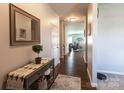 Inviting entryway with wood floors, stylish console table, mirror, and seamless transition to the living spaces at 177 Willow Valley Dr, Mooresville, NC 28115