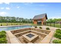 Pool with a fire pit and an outdoor shed at 1822 Irby Rd, Monroe, NC 28112