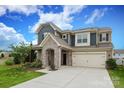 Two-story home with stone archway, two-car garage, and driveway at 1914 Loggerhead Dr, Lancaster, SC 29720