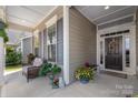 Cozy covered front porch with decorative planters and a wreath on the front door at 2021 Pinyon Ln, Lancaster, SC 29720