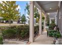 Inviting covered front porch with landscaping and an outdoor seating area at 2021 Pinyon Ln, Lancaster, SC 29720