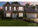 Charming two-story home with a well-manicured lawn, blue door, and an attached two-car garage at 204 Pebble Creek Xing, Fort Mill, SC 29715