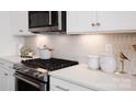 Close-up of a kitchen featuring stainless steel appliances and elegant backsplash at 2066 Skyhawk Dr, York, SC 29745
