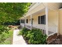 Charming front porch with white railings, complemented by manicured landscaping and a walkway leading to the entrance at 219 Proctor Dr, Salisbury, NC 28147