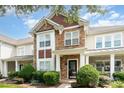 Attractive townhome with stone and siding, featuring a covered porch and neat landscaping at 2324 Bonterra Blvd, Indian Trail, NC 28079